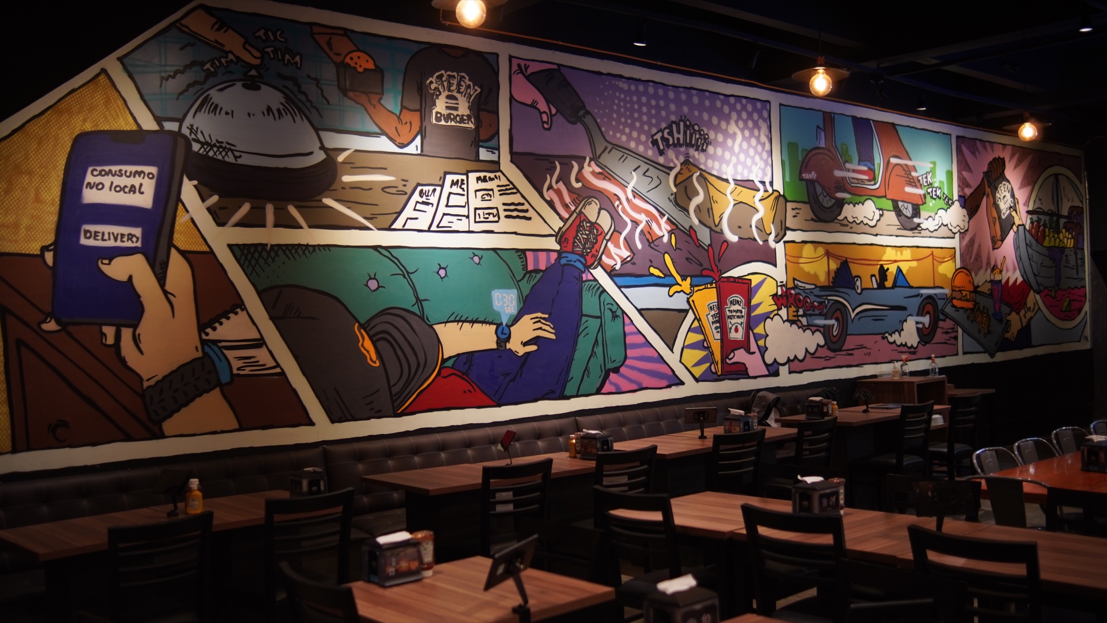 Salão da Steen Burger com mural colorido